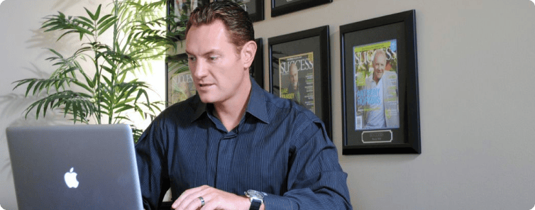 portrait-cafe-owner-young-man-sitting-coffee-shop-with-laptop-working-data-project-looking